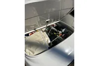 Open storage compartment on 2023 Solaris Power 40 Open boat, filled with various items.