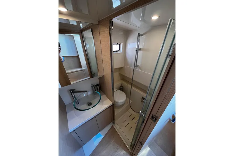 Esimar Yacht Photos Pics Modern bathroom interior on 2023 Solaris Power 40 Open yacht, featuring sleek design and glass fixtures.