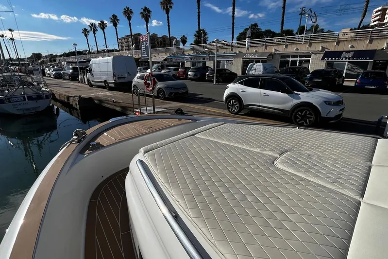 Esimar Yacht Photos Pics 2023 Solaris Power 40 Open yacht docked at a marina with parked cars nearby.