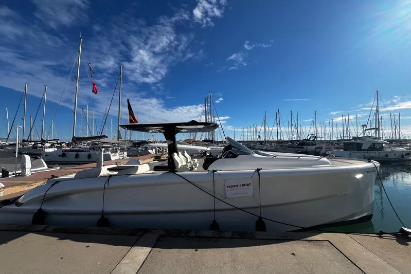 Esimar Yacht Photos Pics 2023 Solaris Power 40 Open yacht docked in a marina under a clear blue sky.