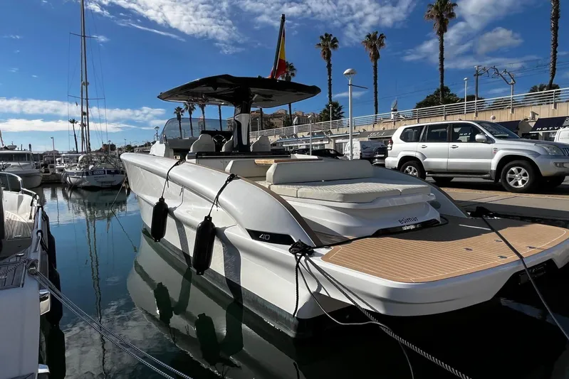 Esimar Yacht Photos Pics 2023 Solaris Power 40 Open yacht docked in marina under clear blue sky.