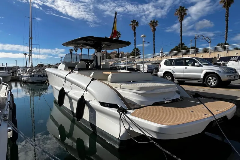 Esimar Yacht Photos Pics 2023 Solaris Power 40 Open yacht docked in a sunny marina, with clear skies and palm trees.