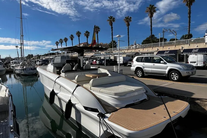 Esimar Yacht Photos Pics 2023 Solaris Power 40 Open yacht docked at marina under blue sky.