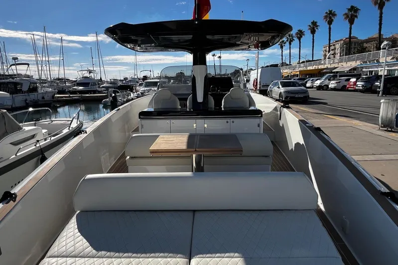 Esimar Yacht Photos Pics 2023 Solaris Power 40 Open yacht docked at a marina with palm trees and parked cars.