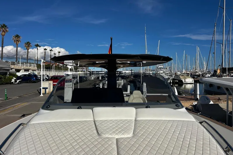 Esimar Yacht Photos Pics 2023 Solaris Power 40 Open yacht docked at a marina under a clear blue sky.