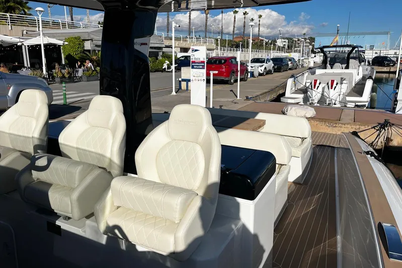 Esimar Yacht Photos Pics 2023 Solaris Power 40 Open yacht with luxurious seating at a marina.