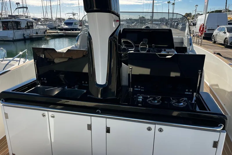 Esimar Yacht Photos Pics 2023 Solaris Power 40 Open yacht with sleek kitchen and control area at marina.