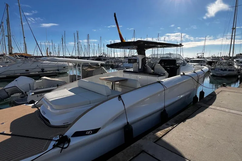 Esimar Yacht Photos Pics 2023 Solaris Power 40 Open yacht docked in a marina under a clear blue sky.