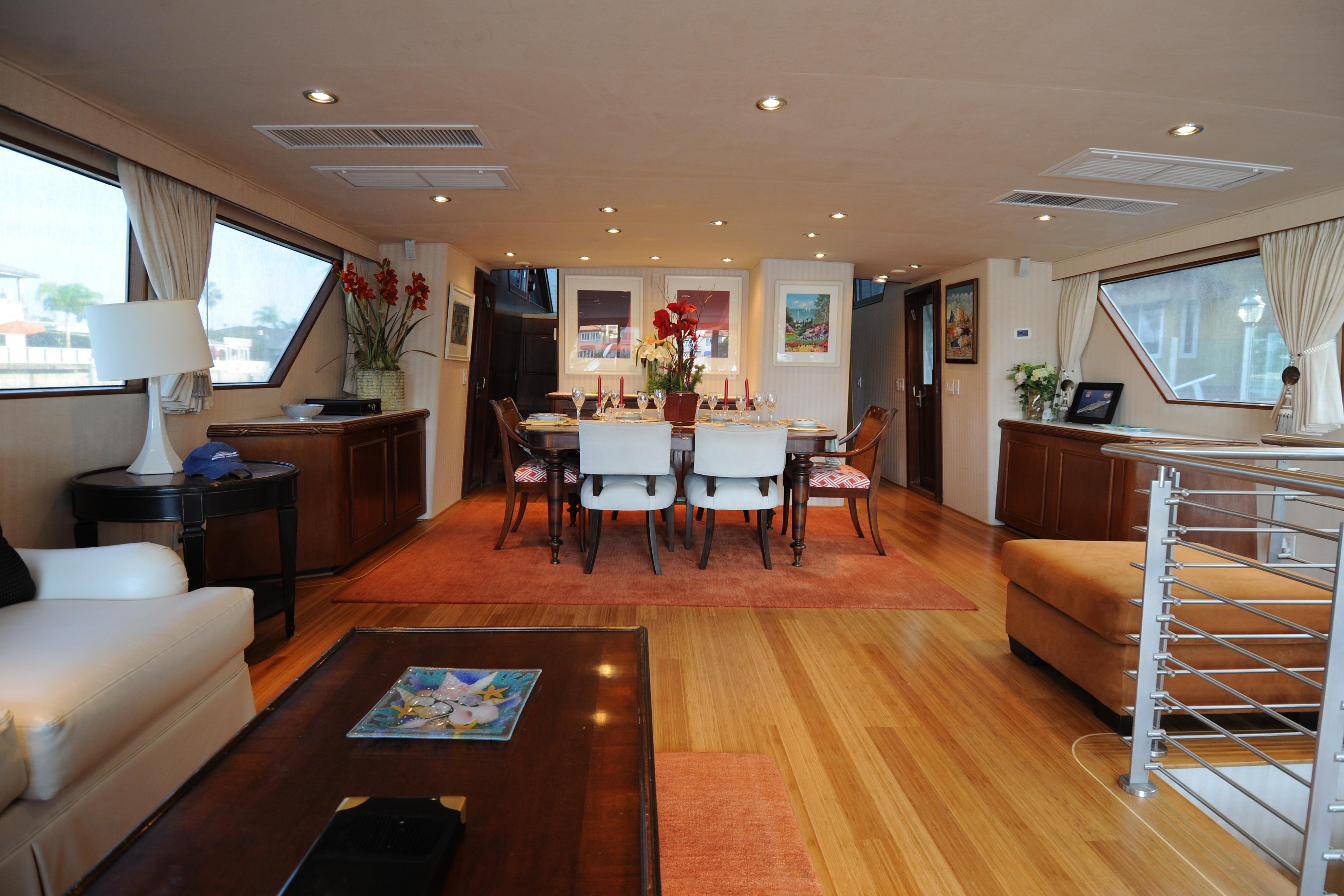 Luxurious interior of 1987 Broward Cockpit Motor Yacht with elegant dining area and decor.
