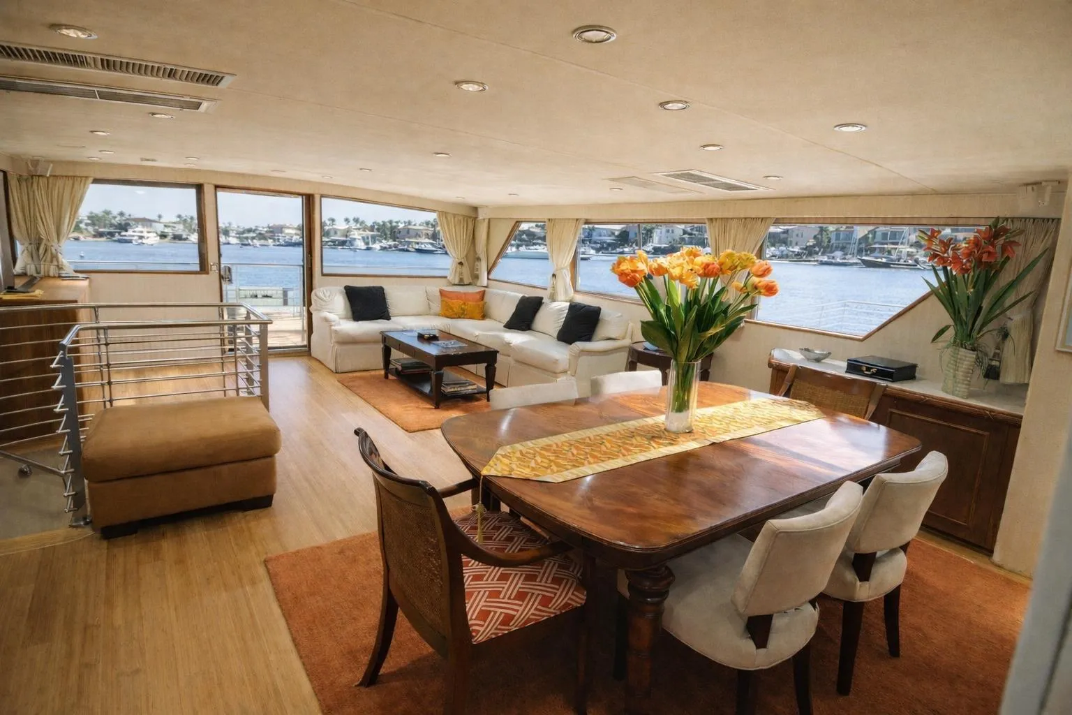 Luxurious 1987 Broward Cockpit Motor Yacht interior with elegant dining area and waterfront views.