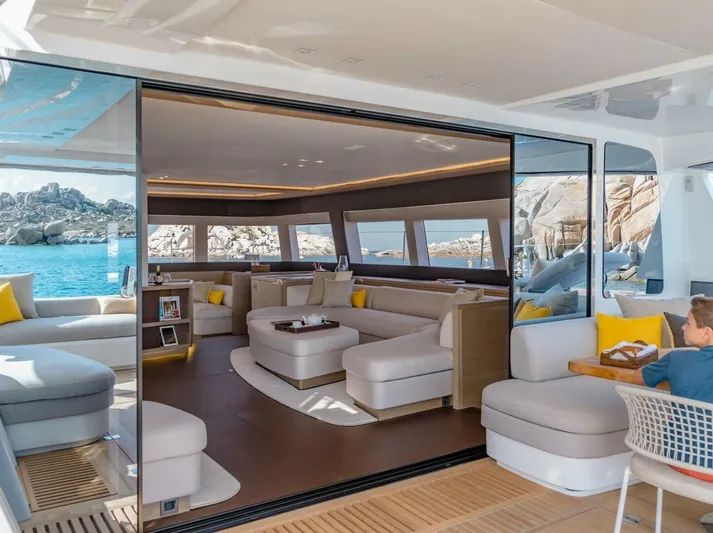 Sicilian Breeze Yacht Photos Pics Luxurious interior of 2021 Lagoon Seventy 7 yacht with modern seating and ocean view.