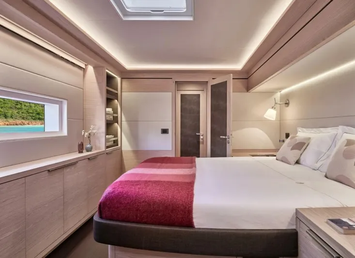 Sicilian Breeze Yacht Photos Pics Luxurious bedroom interior of 2021 Lagoon Seventy 7 yacht with modern design and cozy ambiance.