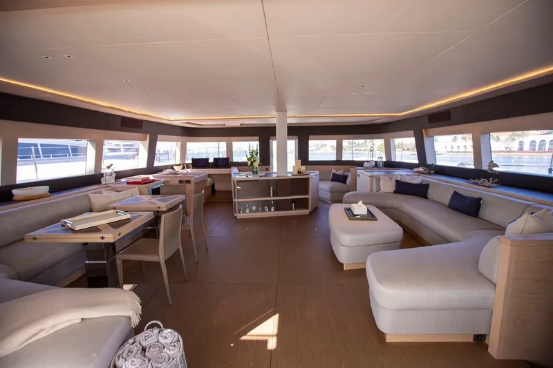 Sicilian Breeze Yacht Photos Pics Luxurious interior of 2021 Lagoon Seventy 7 yacht with elegant seating and panoramic windows.