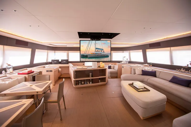 Sicilian Breeze Yacht Photos Pics Luxurious interior of 2021 Lagoon Seventy 7 yacht with modern furnishings and large windows.