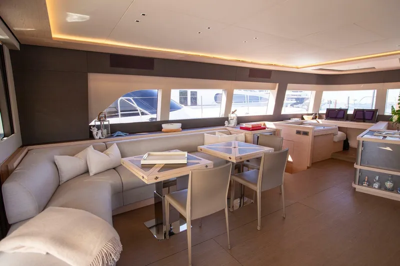 Sicilian Breeze Yacht Photos Pics Luxurious interior of 2021 Lagoon Seventy 7 yacht with modern seating and large windows.
