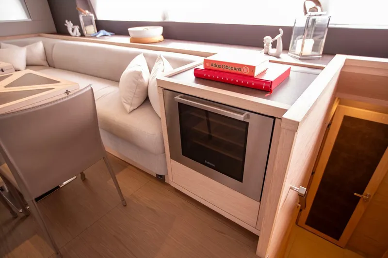 Sicilian Breeze Yacht Photos Pics Luxurious interior of 2021 Lagoon Seventy 7 yacht with modern seating and built-in oven.
