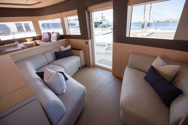 Sicilian Breeze Yacht Photos Pics Luxurious interior of 2021 Lagoon Seventy 7 yacht with elegant seating and ocean view.