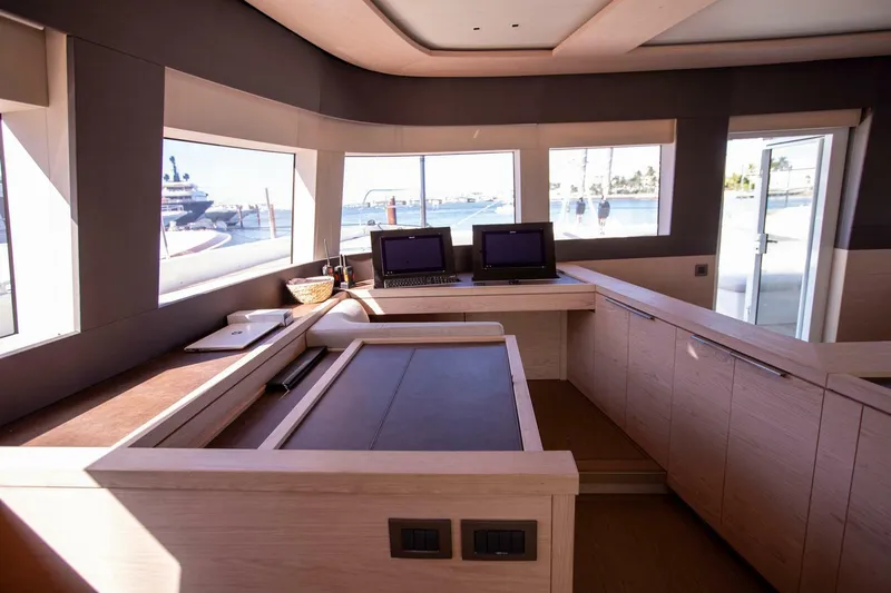 Sicilian Breeze Yacht Photos Pics Interior of 2021 Lagoon Seventy 7 yacht with modern navigation station and panoramic windows.