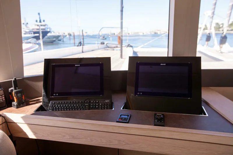 Sicilian Breeze Yacht Photos Pics Control panel of 2021 Lagoon Seventy 7 yacht with dual screens and keyboard.
