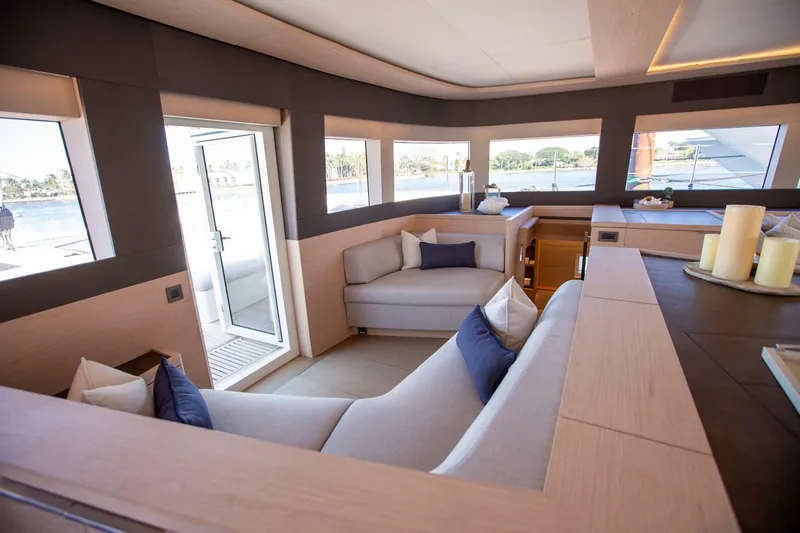 Sicilian Breeze Yacht Photos Pics Luxurious interior of 2021 Lagoon Seventy 7 yacht with modern seating and panoramic windows.
