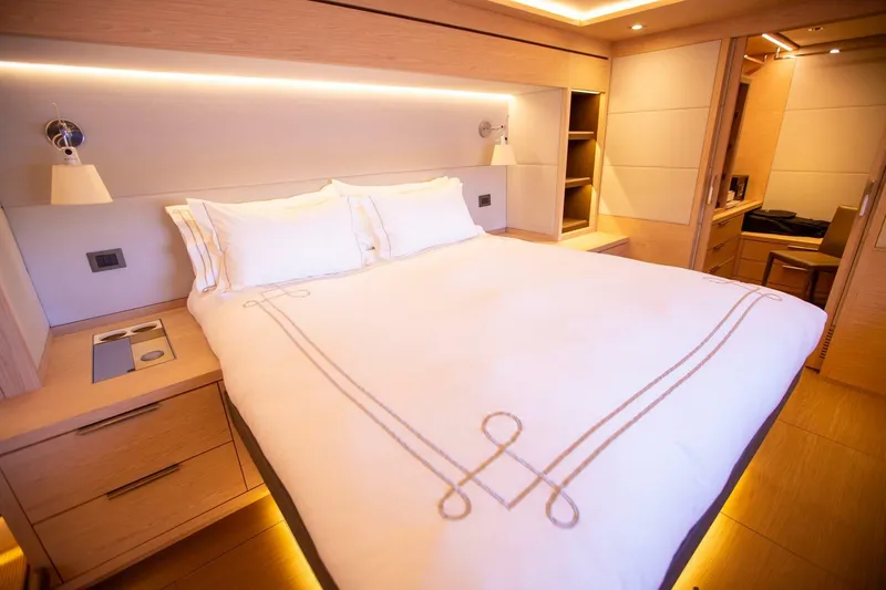 Sicilian Breeze Yacht Photos Pics Luxurious bedroom interior of 2021 Lagoon Seventy 7 yacht with elegant bedding.