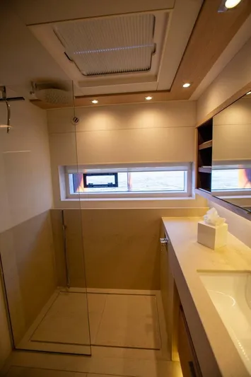 Sicilian Breeze Yacht Photos Pics Luxurious bathroom interior of 2021 Lagoon Seventy 7 yacht with modern fixtures.