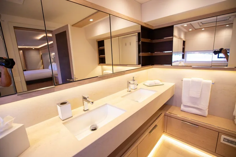 Sicilian Breeze Yacht Photos Pics Luxurious bathroom in a 2021 Lagoon Seventy 7 yacht with dual sinks and modern design.