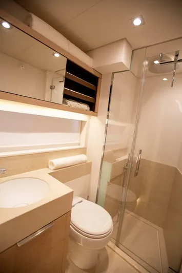 Sicilian Breeze Yacht Photos Pics Luxurious bathroom in 2021 Lagoon Seventy 7 yacht with modern fixtures and glass shower.