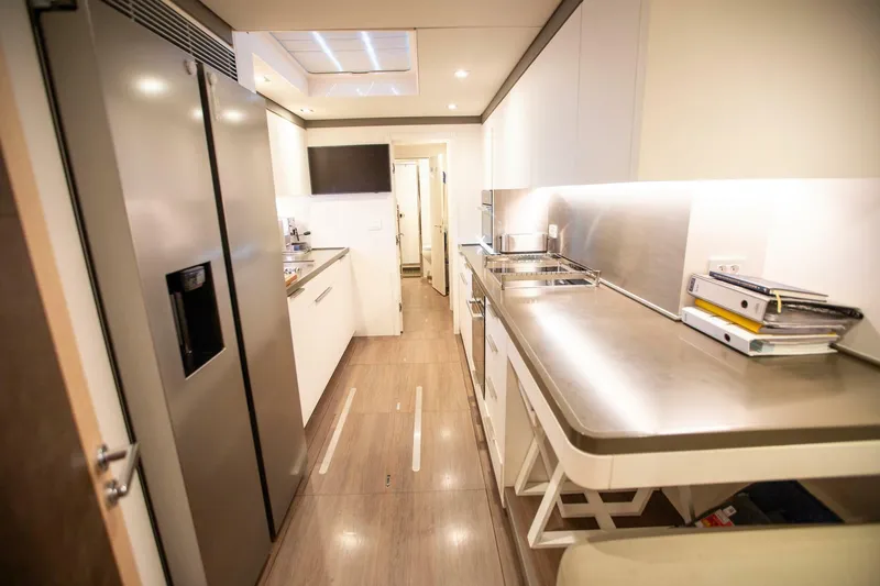 Sicilian Breeze Yacht Photos Pics Luxurious 2021 Lagoon Seventy 7 yacht kitchen with modern appliances and sleek design.