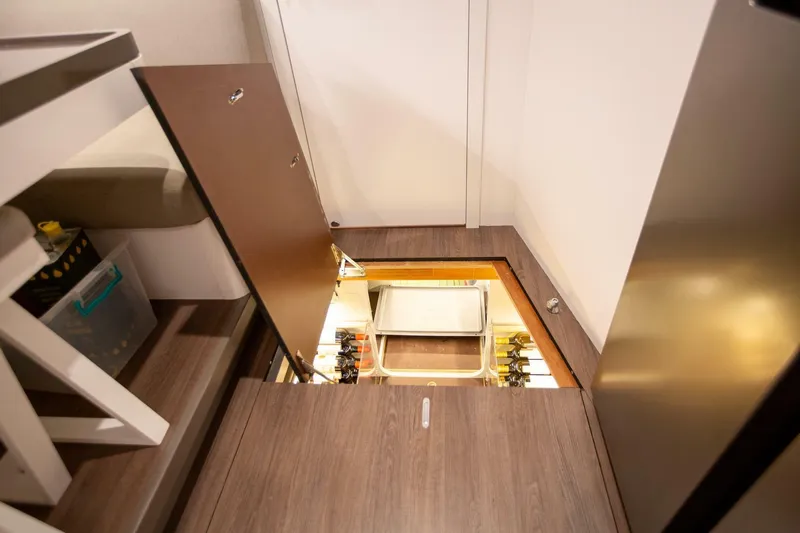 Sicilian Breeze Yacht Photos Pics Interior of 2021 Lagoon Seventy 7 yacht with open floor storage compartment.