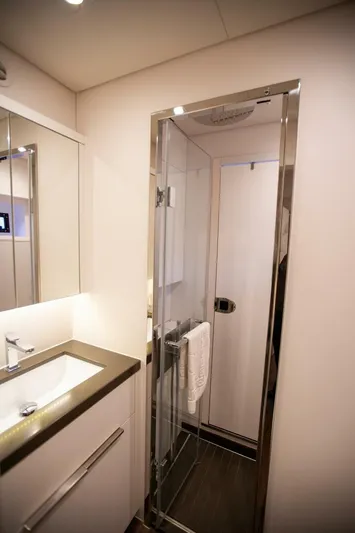 Sicilian Breeze Yacht Photos Pics Luxurious bathroom in 2021 Lagoon Seventy 7 yacht with sleek shower and modern sink.