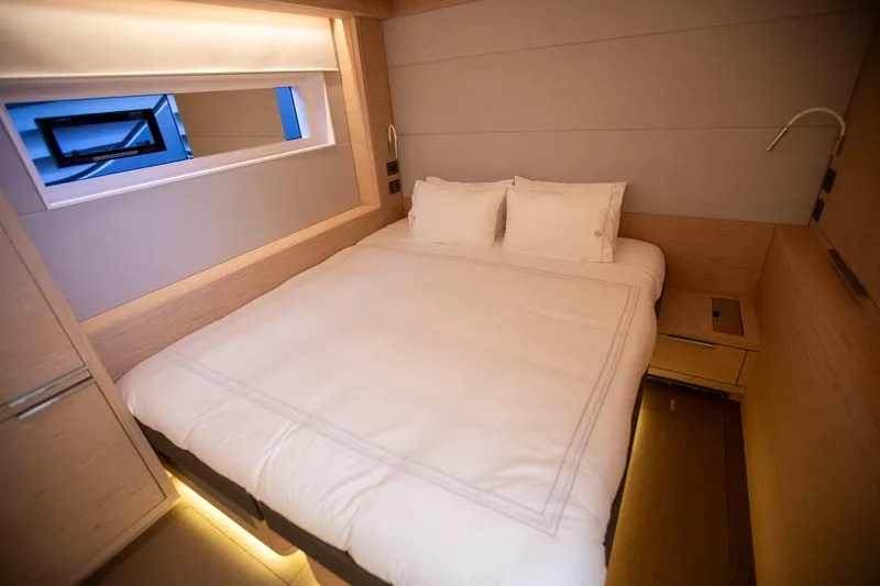 Sicilian Breeze Yacht Photos Pics Luxurious bedroom interior of 2021 Lagoon Seventy 7 yacht with modern design and ambient lighting.