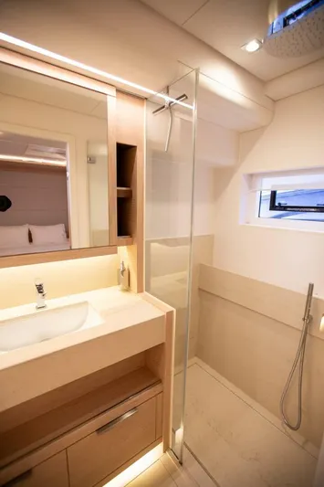 Sicilian Breeze Yacht Photos Pics Luxurious bathroom in 2021 Lagoon Seventy 7 yacht with modern fixtures and glass shower.