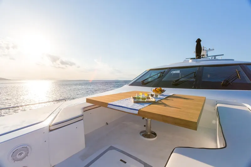 Aquarella Yacht Photos Pics Luxurious Devonport  yacht deck with table, ocean view, and sunset ambiance.