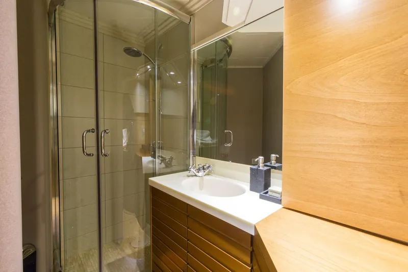 Aquarella Yacht Photos Pics Luxurious bathroom on Devonport  yacht, featuring modern shower and sleek wooden cabinetry.