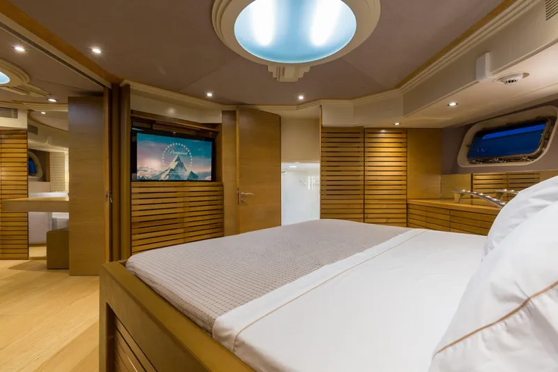 Aquarella Yacht Photos Pics Luxurious bedroom interior on 1994 Devonport yacht, featuring modern wood paneling and ambient lighting.