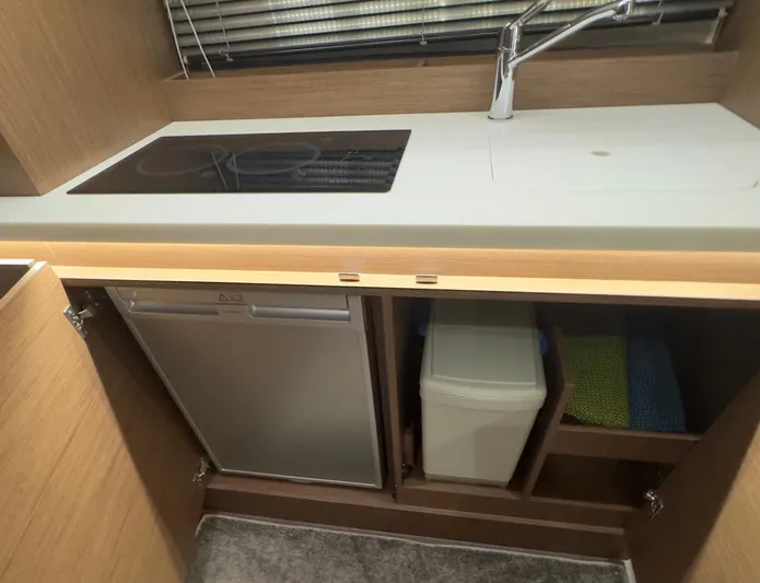 Yacht Photos Pics Modern kitchen area in 2021 Jeanneau Leader 12.5 WA boat with stove and storage.