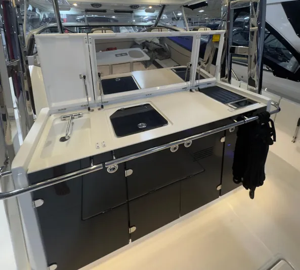  Yacht Photos Pics 2021 Jeanneau Leader 12.5 WA boat kitchen area with sink and storage cabinets.