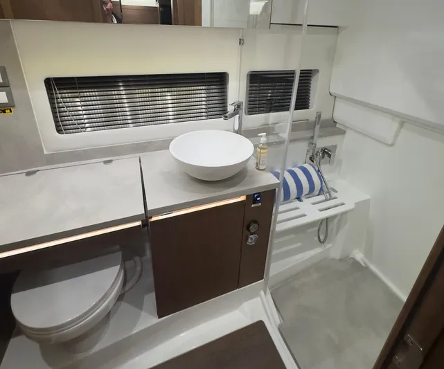  Yacht Photos Pics 2021 Jeanneau Leader 12.5 WA bathroom with modern sink, toilet, and shower area.