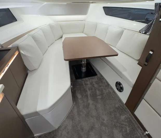  Yacht Photos Pics Interior of 2021 Jeanneau Leader 12.5 WA boat with cozy seating and table.