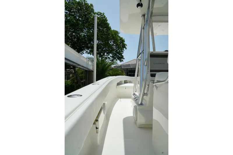  Yacht Photos Pics 2017 SeaVee 34Z boat deck with Garmin equipment, surrounded by lush greenery.