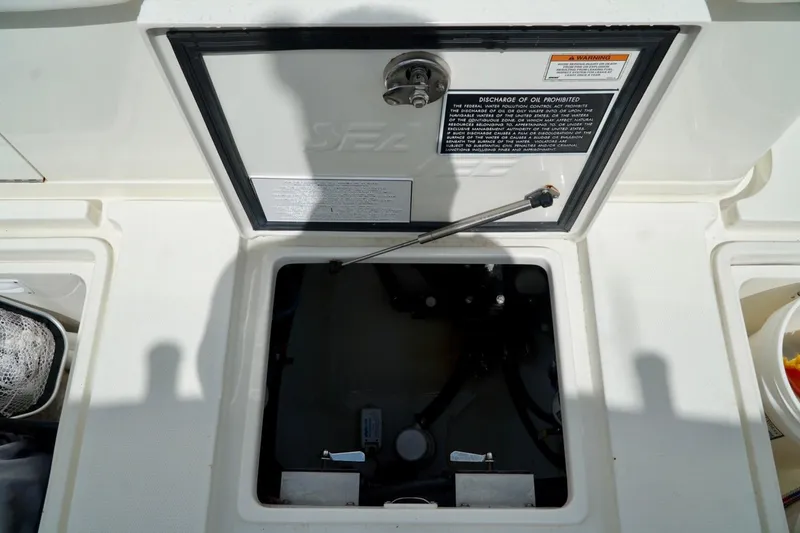 Yacht Photos Pics 2017 SeaVee 34Z boat compartment with open hatch and warning labels.