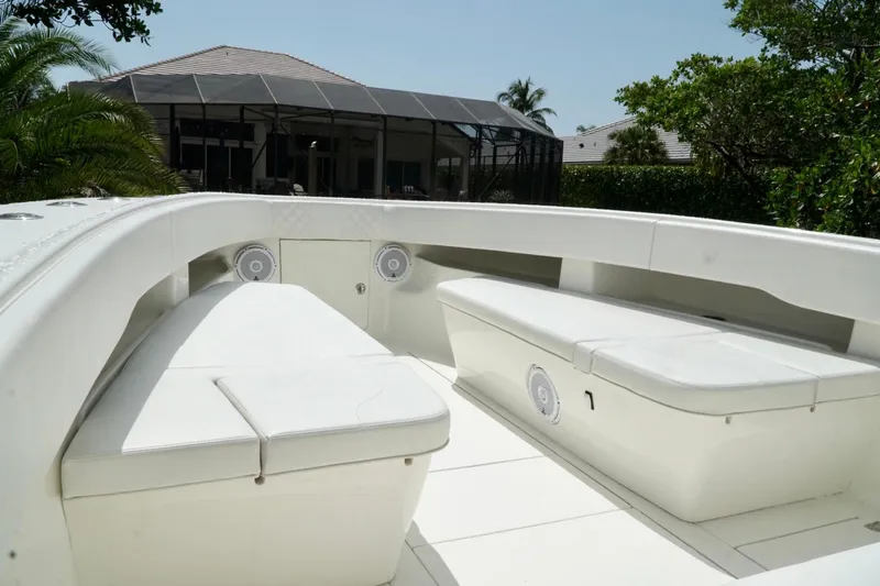  Yacht Photos Pics 2017 SeaVee 34Z boat interior with white seating and speakers, surrounded by greenery.