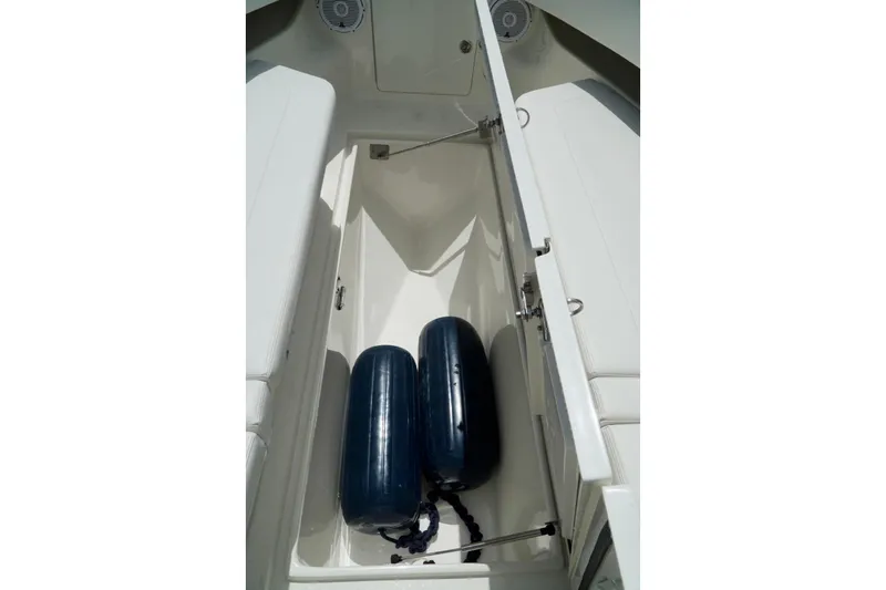  Yacht Photos Pics Open storage compartment on 2017 SeaVee 34Z boat with blue fenders inside.