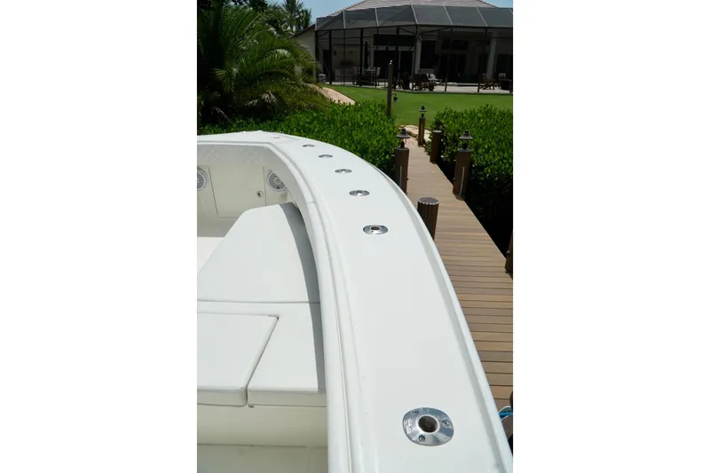  Yacht Photos Pics 2017 SeaVee 34Z boat bow with dock and lush greenery in background.