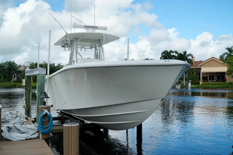  Yacht Photos Pics 2017 SeaVee 34Z boat docked on a serene waterfront with clear skies.