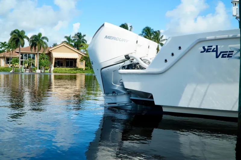  Yacht Photos Pics 2017 SeaVee 34Z boat with Mercury engines on a calm waterfront.