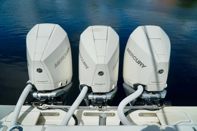  Yacht Photos Pics Triple Mercury Verado engines on a 2017 SeaVee 34Z boat, docked on calm water.