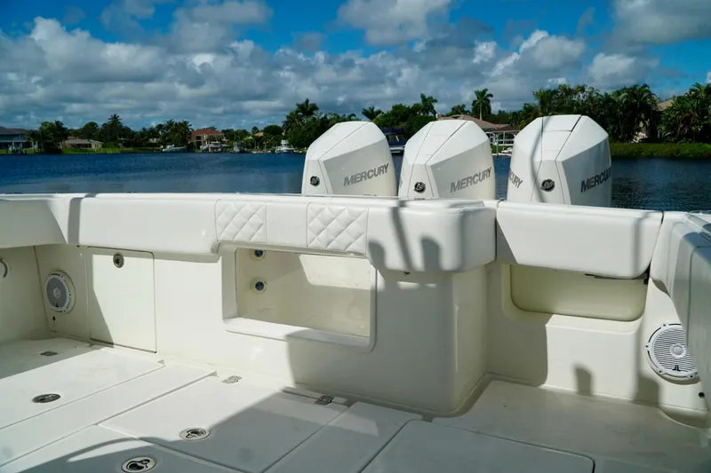  Yacht Photos Pics 2017 SeaVee 34Z boat with triple Mercury engines on a sunny day by the water.