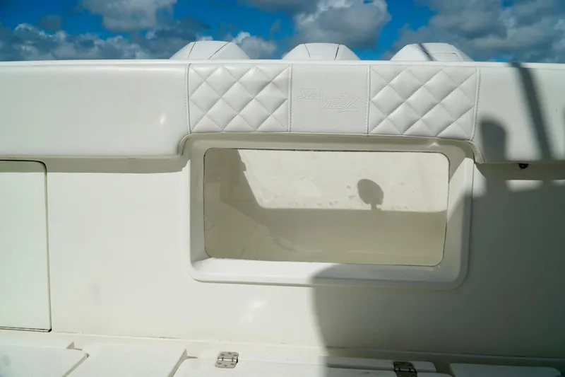  Yacht Photos Pics 2017 SeaVee 34Z boat interior with white cushioned seating and storage compartment.
